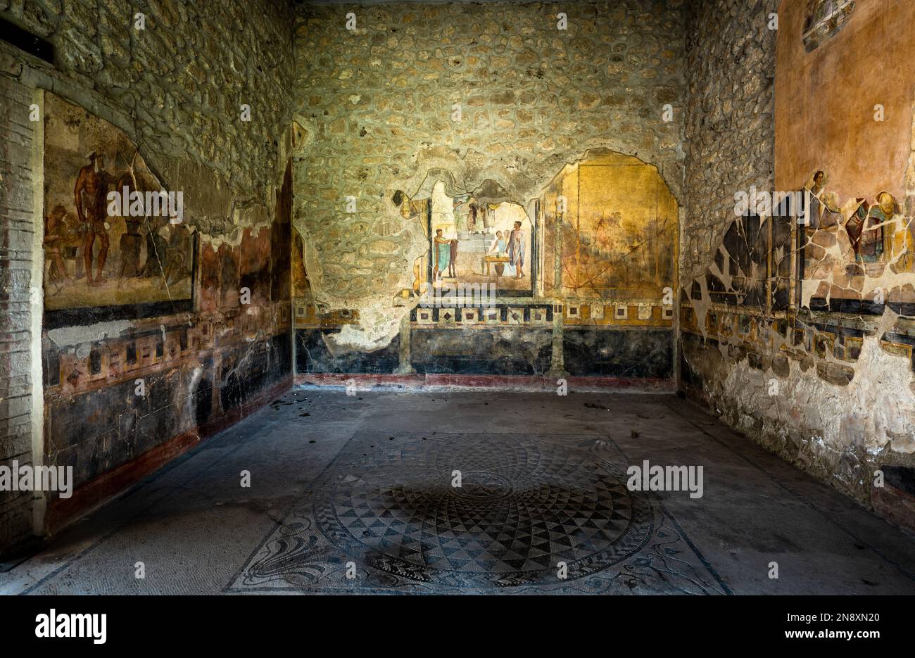 Room of well preserved frescoes and mosaics in the Casa Degli Amorini in the ruins of Pompeii Stock Photo