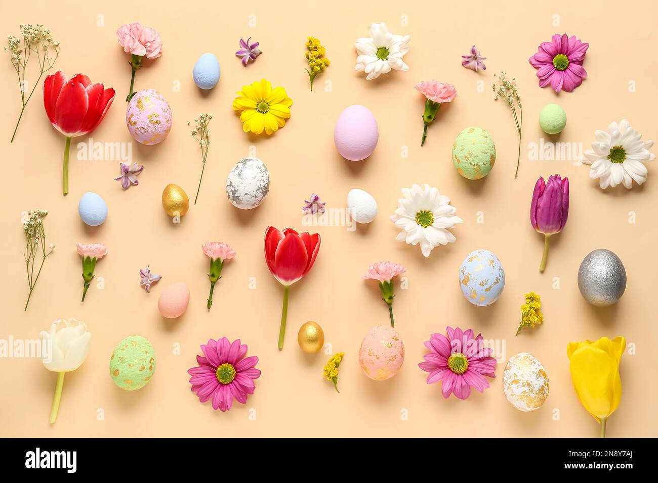 Composition with Easter eggs and different flowers on color background ...