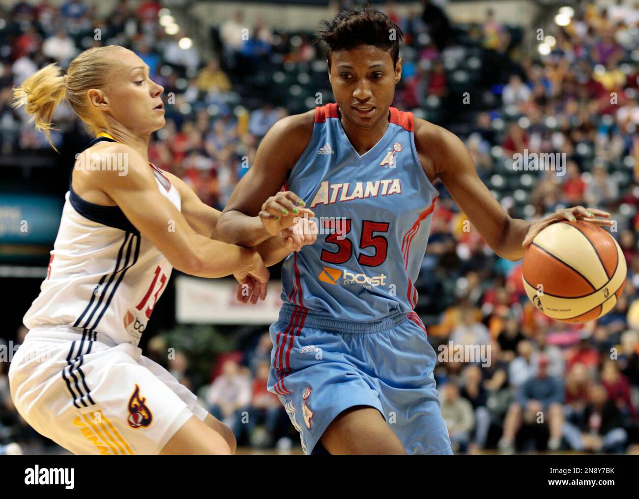 Atlanta Dream guard Angel McCoughtry, right, dribbles around Indiana Fever guard Erin Phillips during the first half of a WNBA basketball first-round playoff game in Indianapolis, Tuesday, Oct. 2, 2012. (AP Photo/AJ Mast) Stock Photo