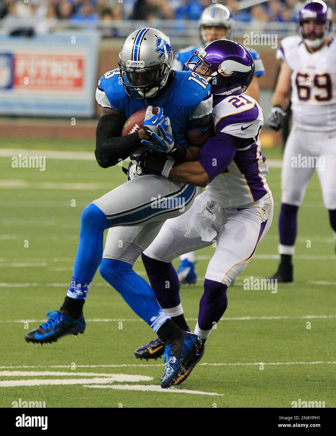 Detroit Lions wide receiver Nate Burleson (13) is tackled by Minnesota Vikings cornerback Josh Robinson (21) during the second quarter of an NFL football game at Ford Field in Detroit, Sunday, Sept. 30, 2012. (AP Photo/Carlos Osorio) Stock Photo