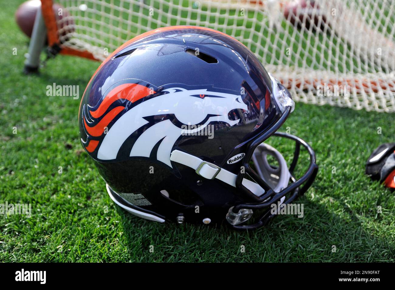 A Denver Broncos helmet sits in the grass during an NFL football game ...