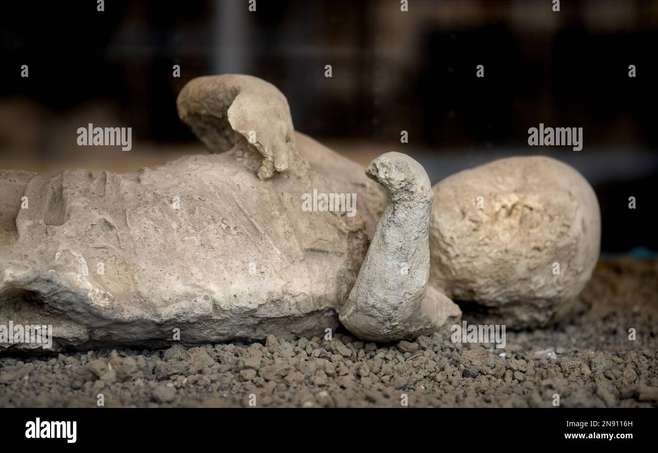 Cast of victim buried by ash by the 79 AD eruption of Mount Vesuvius in Pompeii Stock Photo