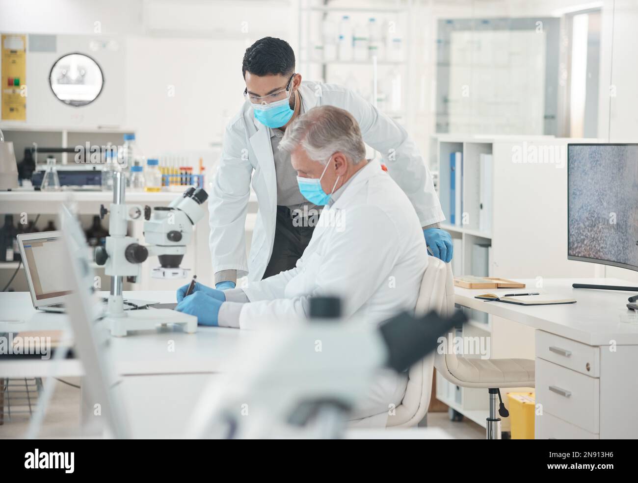 Science is all about extensive work. two scientists working together in a lab. Stock Photo