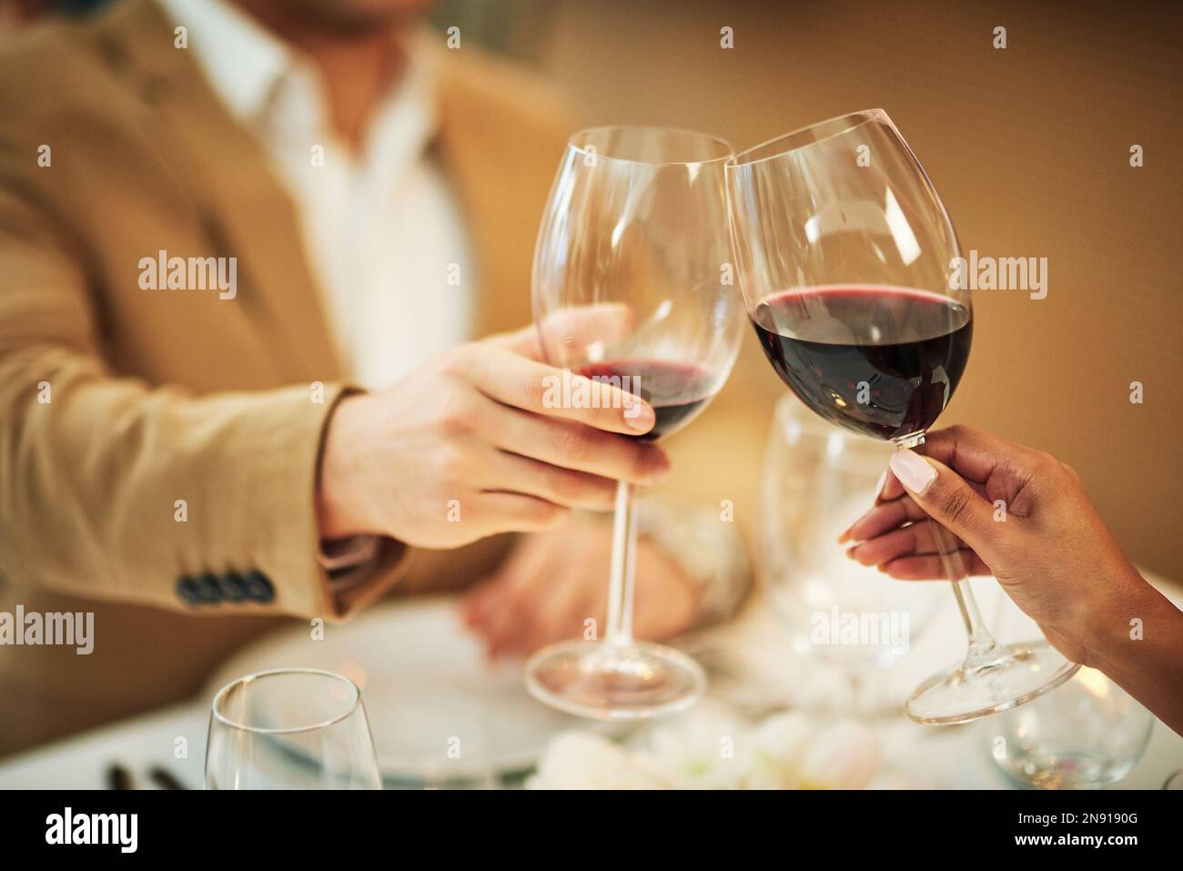 Toast, wine and hands of couple in restaurant for romantic dinner, date