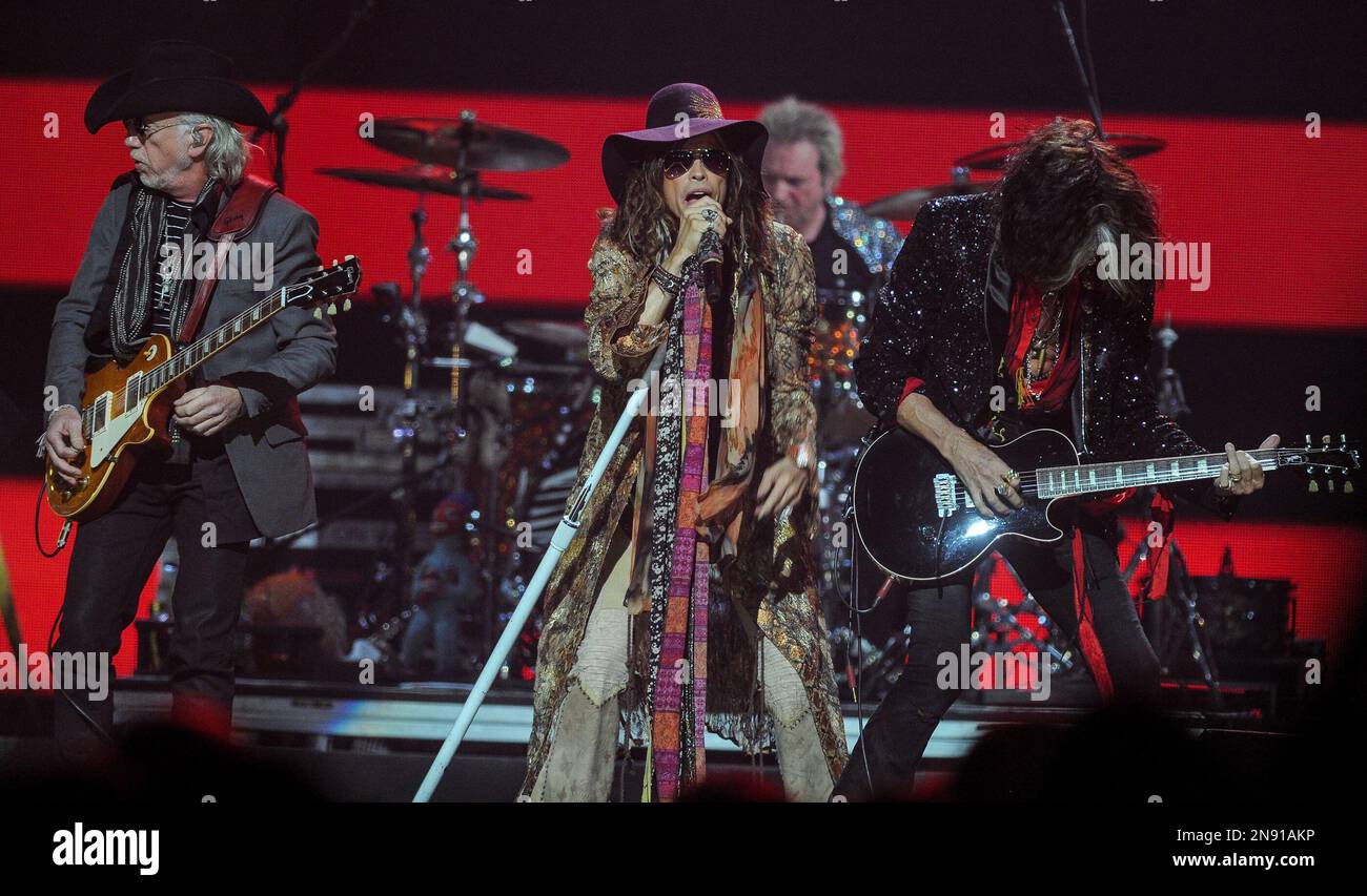 Steven Tyler sings with guitarist Joe Perry, right, and Brad Whiteford,  left, of Aerosmith perform at iHeart Radio Music Festival on Saturday,  Sept., 22, 2012 at the MGM Grand Arena in Las