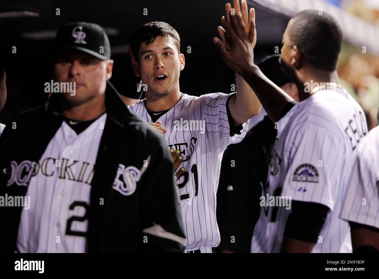 Colorado Rockies' Jason Giambi, left, is congratulated by teammate Troy  Tulowitzki after hitting a three-run home run off Kansas City Royals  starting pitcher Zack Greinke during third inning of a baseball game