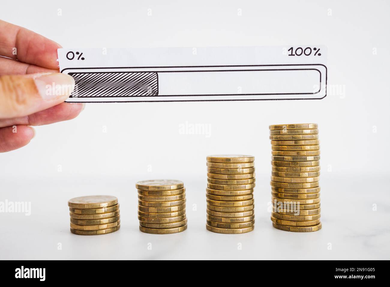 stacks of progressively increasing coins with hand holding  progress bar loading icon, concept of increasing your savings or profits Stock Photo