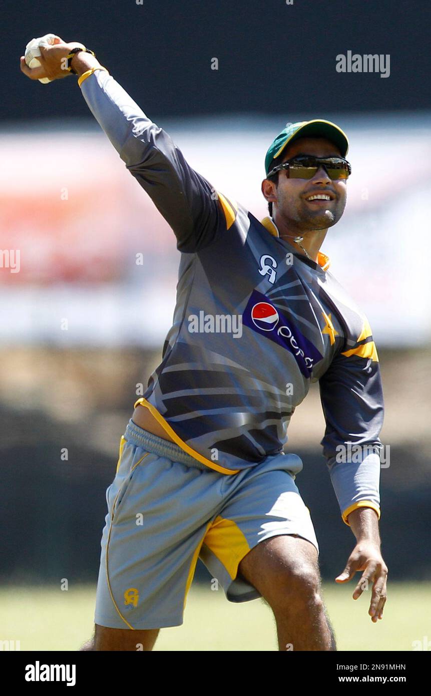 Pakistan's cricketer Umar Akmal prepares to throw the ball during a