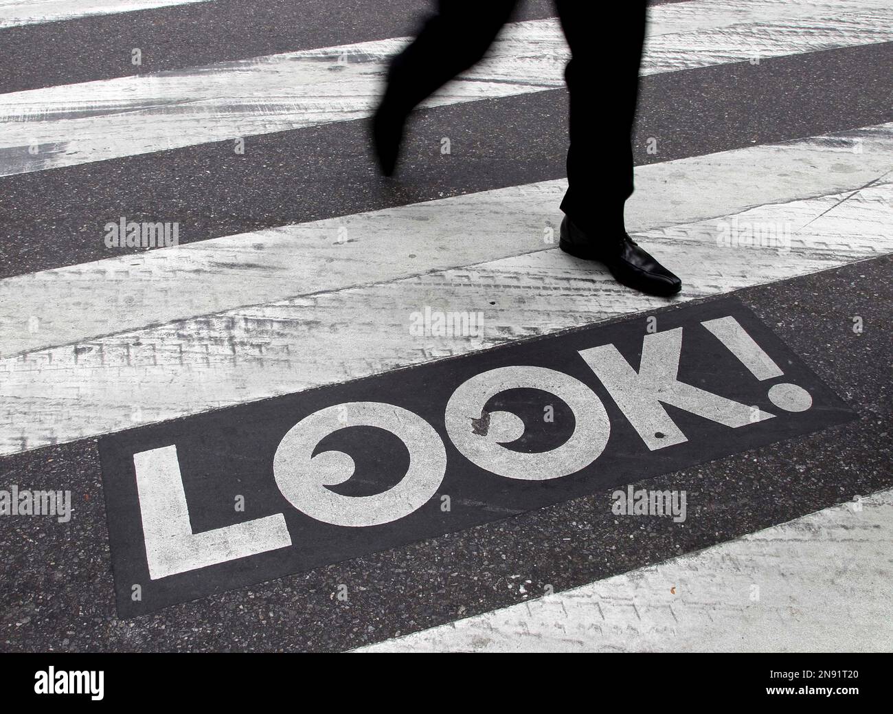 I Look In/sign A pedestrian walks past a
