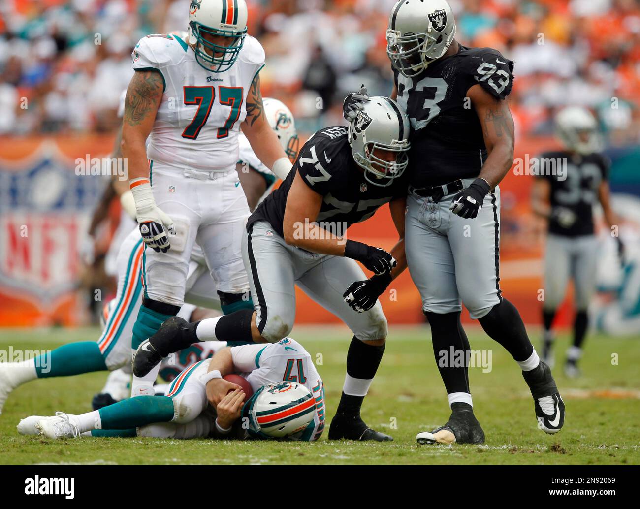 Oakland Raiders defensive tackle Tommy Kelly (93) congratulates
