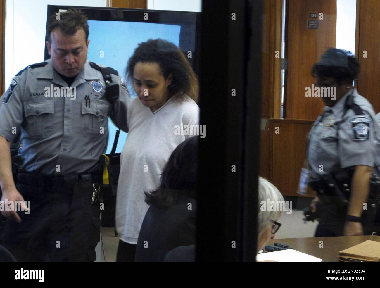 A bailiff escorts Annette Morales-Rodriguez, center, to her seat Tuesday,  Sept. 18, 2012, at her Milwaukee trial to face charges of killing a  pregnant woman and slicing out her full-term fetus in