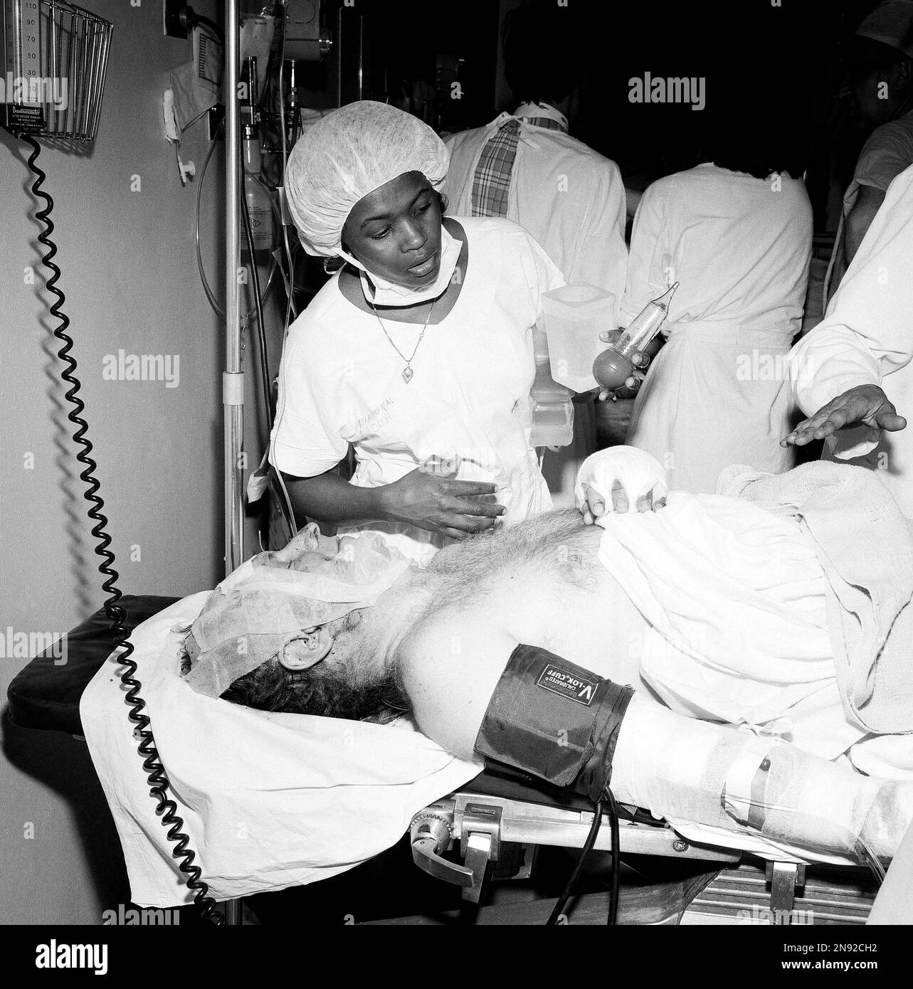 A hospital worker checks on a patient identified as Arthur Marchesi of