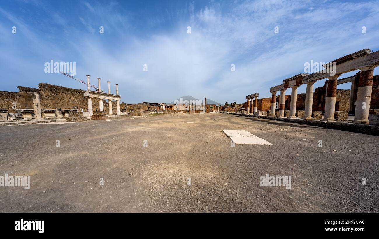 The forum of ancient Pompeii with Temple of Jupiter in the far side and Mount Vesuvius in the background Stock Photo