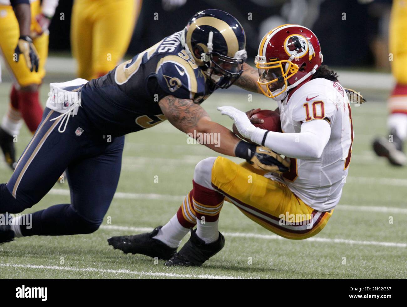 Washington Redskins quarterback Robert Griffin III, right, is hit by St ...