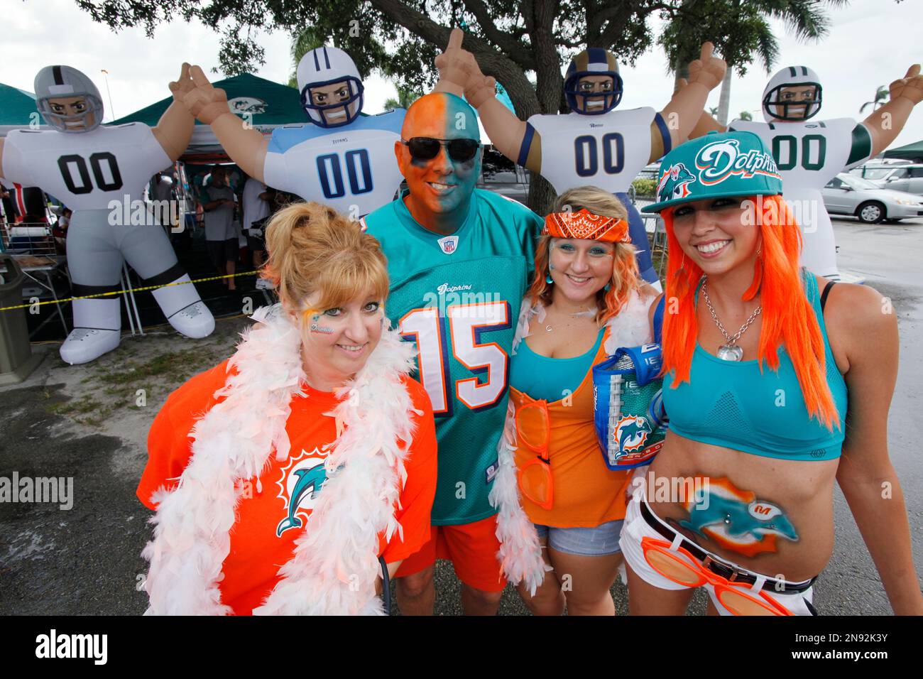 Miami Dolphins fans pose for a photo as they tailgate before the start of  an NFL football game between the Miami Dolphins and the Oakland Raiders,  Sunday, Sept. 16, 2012 in Miami.