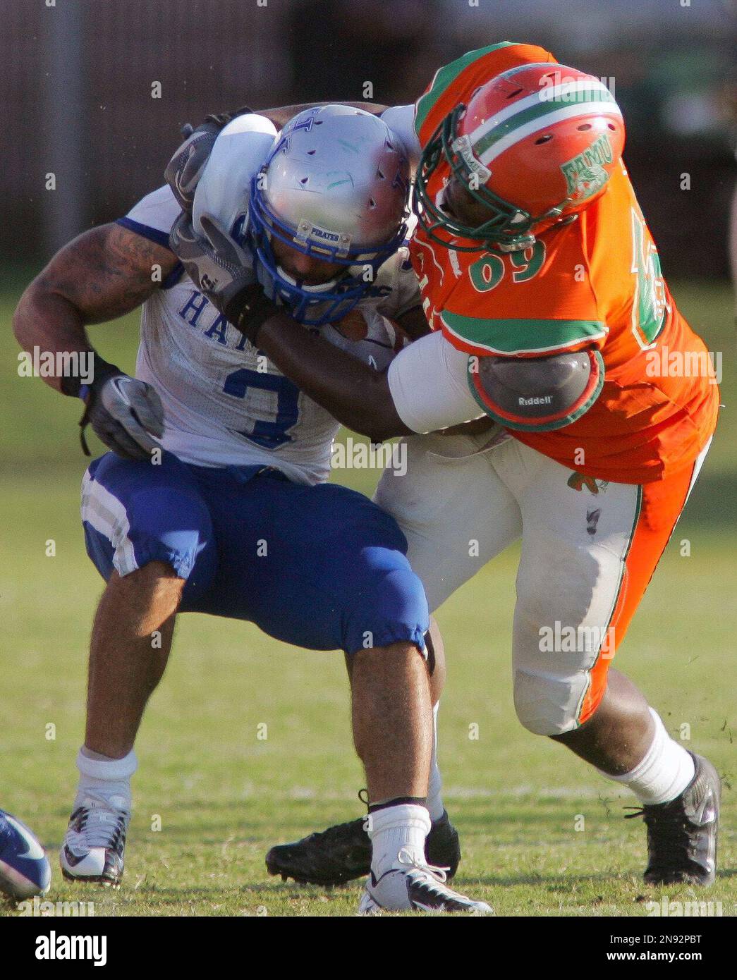 Hampton running back Jeremiah Schwartz (3) has his facemask grabbed by  Florida A&M linebacker Bobby Jackson, top left, during the first half of an  NCAA college football game on Saturday, Sept. 15