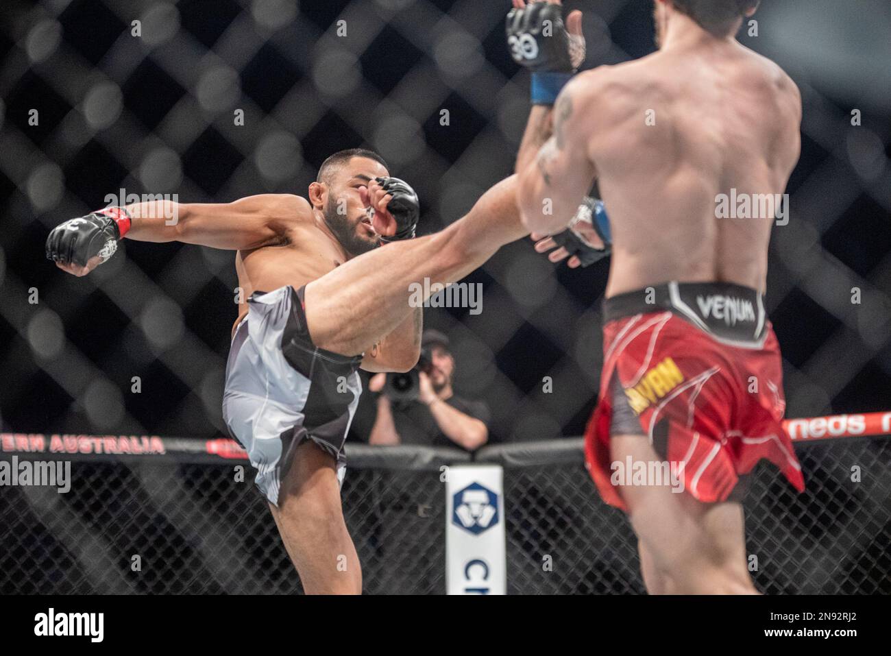 PERTH, AUSTRALIA - FEBRUARY 12: (L-R) Josh Culibao kicks Melsik Baghdasaryan in their Featherweight fight during the UFC 284 event at Rac Arena on February 12, 2023 in Perth, Australia. (Photo by Matt Davies/PxImages) Stock Photo