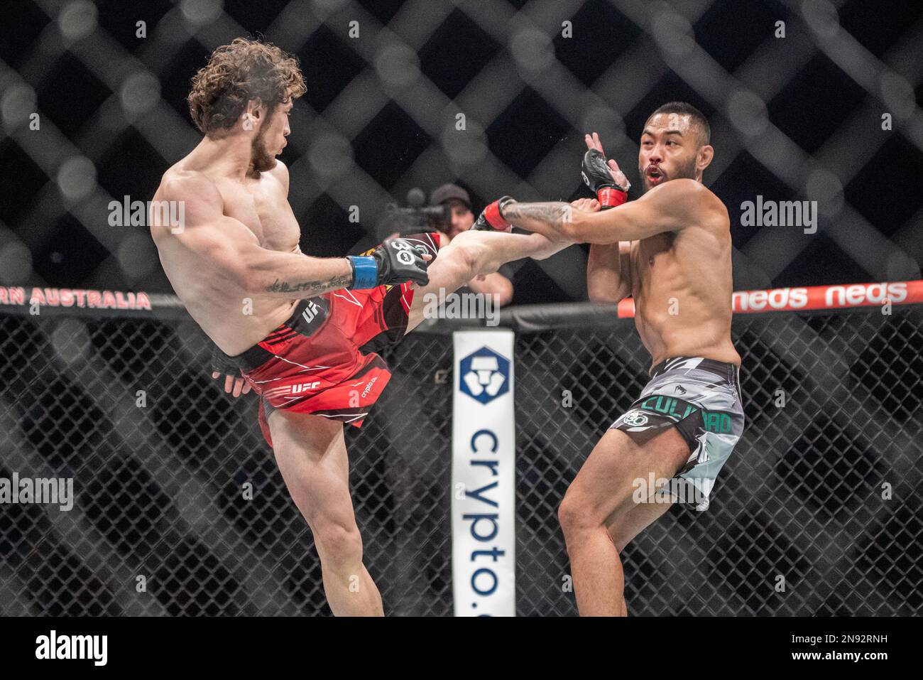 PERTH, AUSTRALIA - FEBRUARY 12: (L-R) Melsik Baghdasaryan kicks Josh Culibao in their Featherweight fight during the UFC 284 event at Rac Arena on February 12, 2023 in Perth, Australia. (Photo by Matt Davies/PxImages) Stock Photo