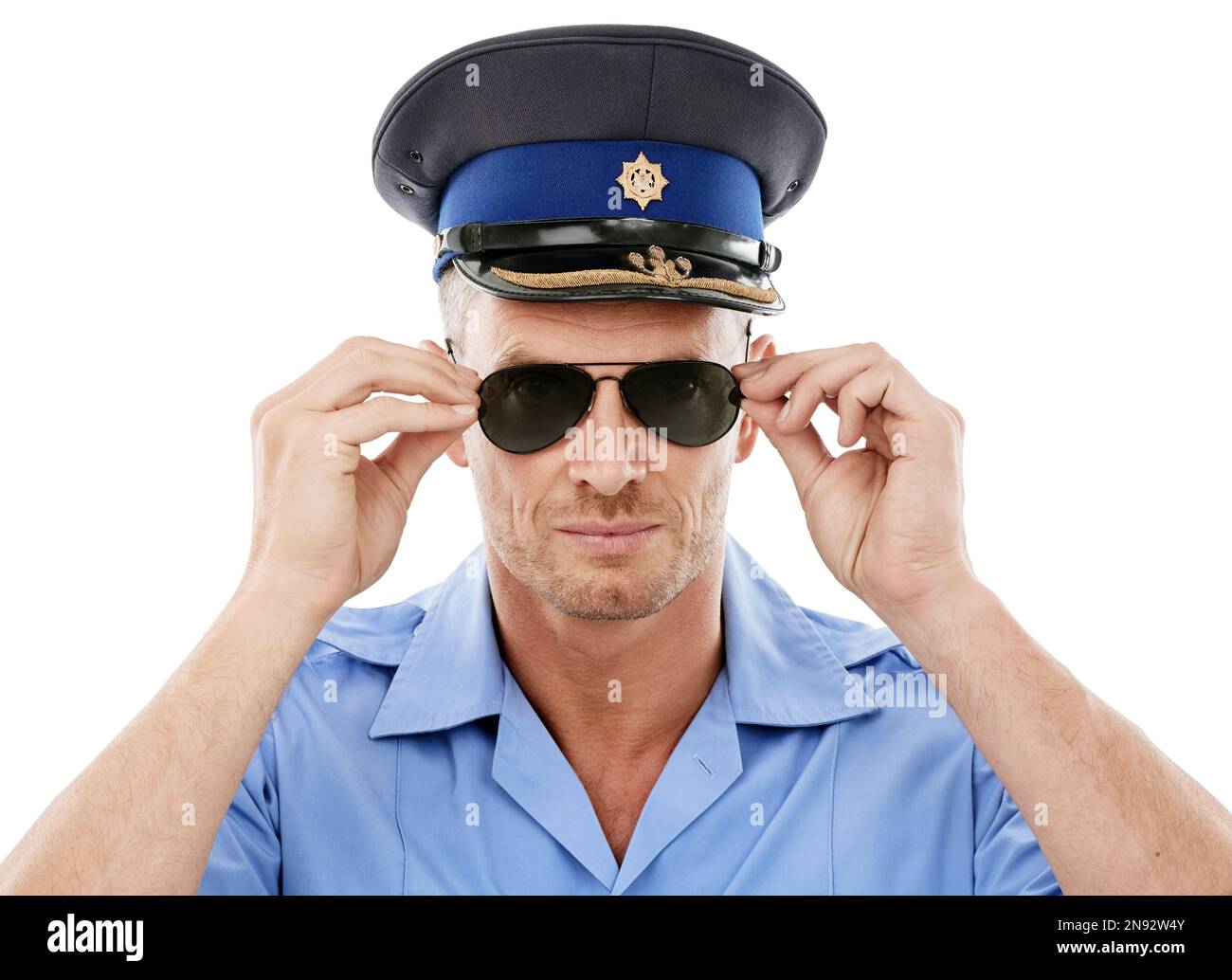 Security, officer and face of police with sunglasses on white background for authority, public safety and crime. Justice, law enforcement and portrait Stock Photo