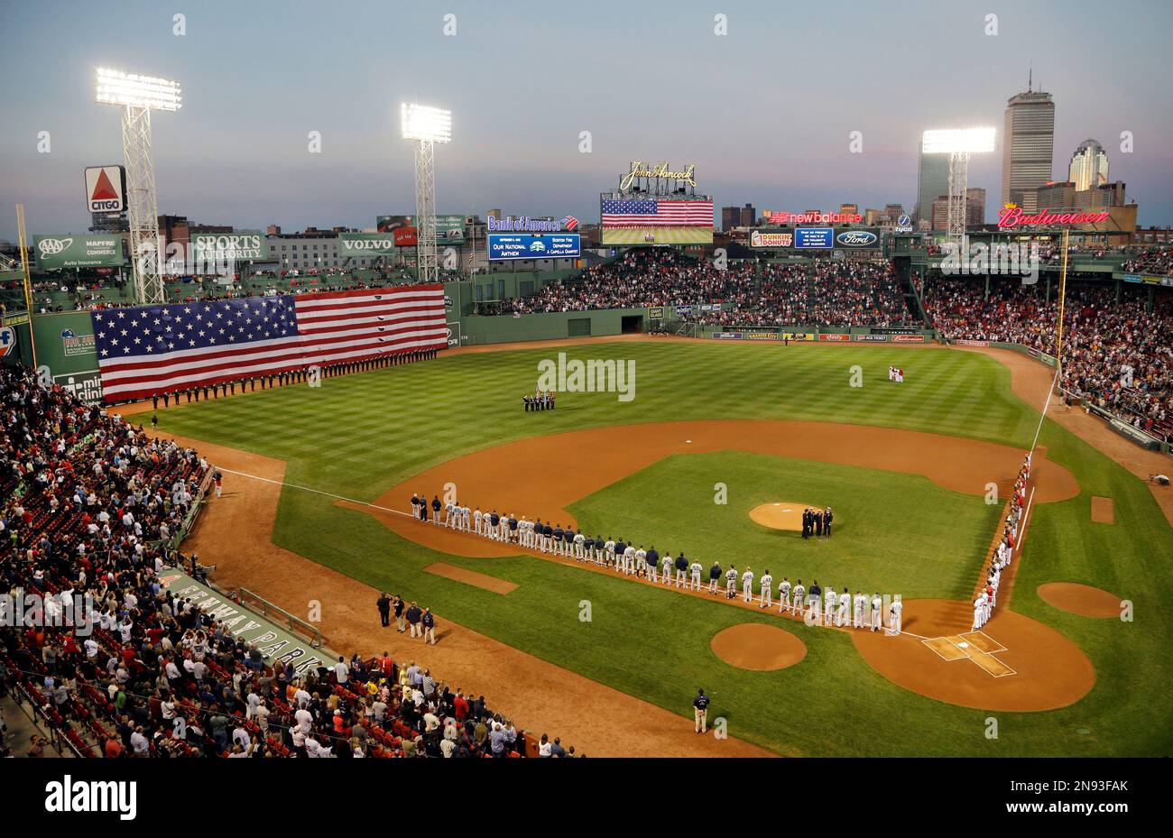 A giant American flag drops down over the left field "Green Monster