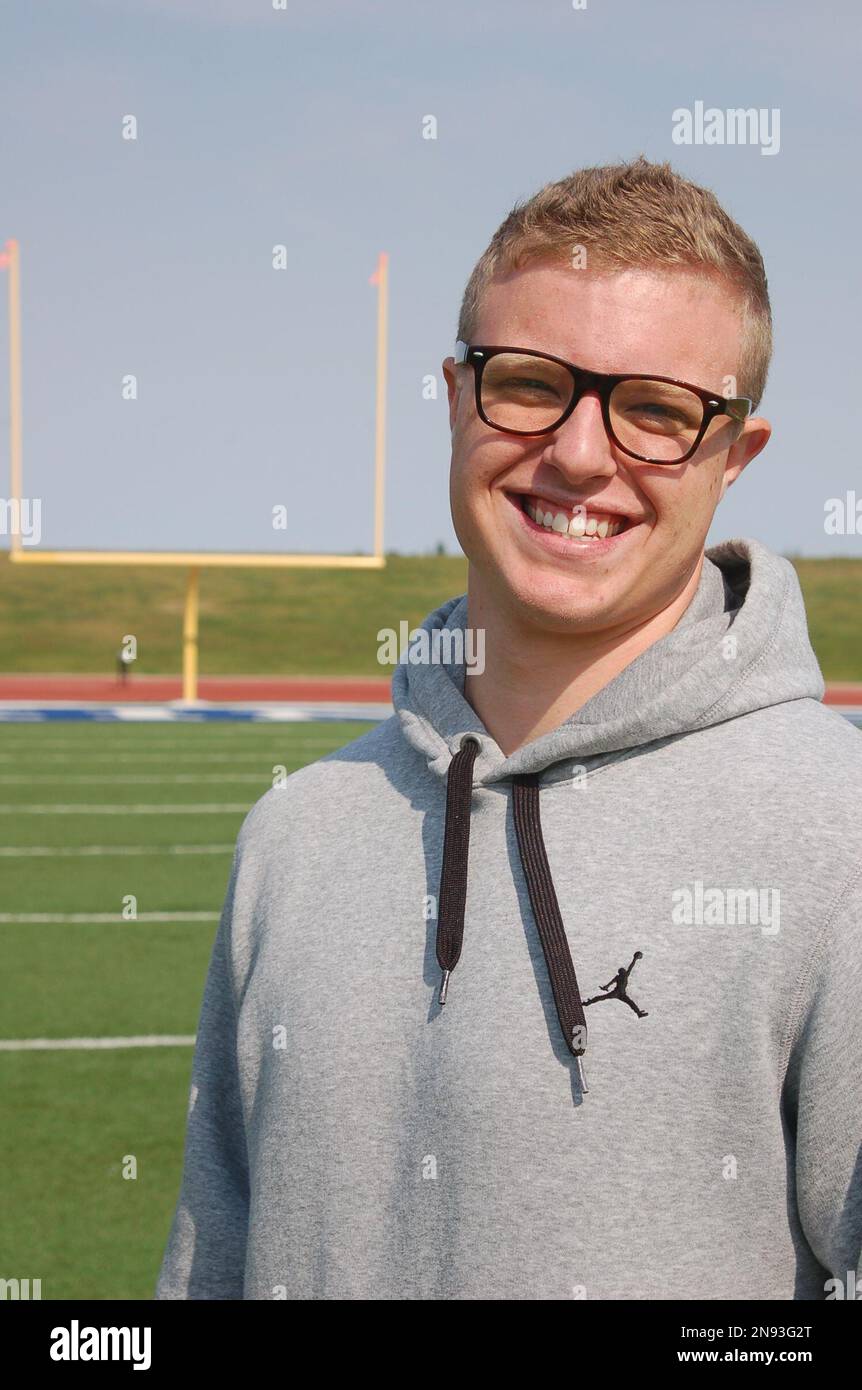 Jamie Kuntz poses for a photograph at a football field