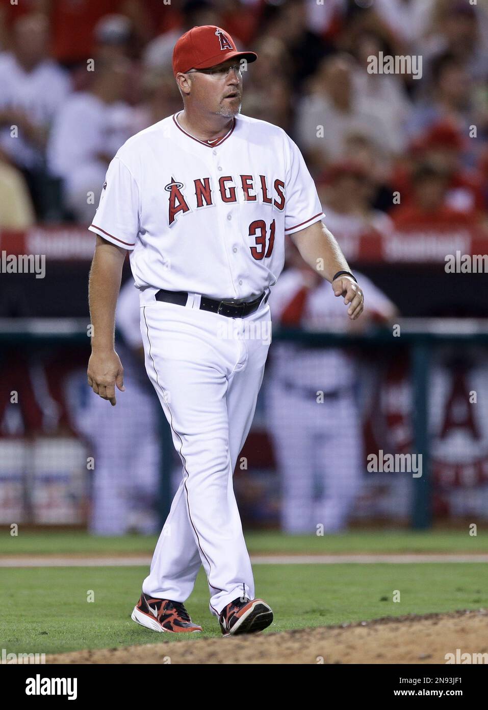 Los Angeles Angels pitching coach Mike Butcher walks to the mound