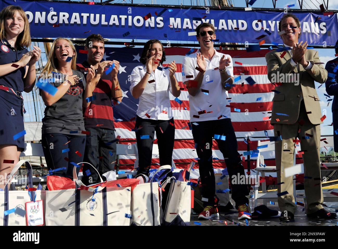 Olympic swimmer Michael Phelps, second from right, joins other Olympic