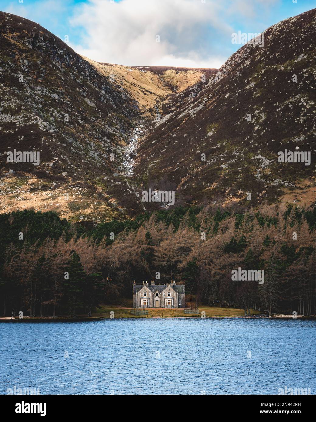 The historical Glas-allt-Shiel lodge by the shore of Loch Muick in Aberdeenshire, Scotland. Vertical shot Stock Photo