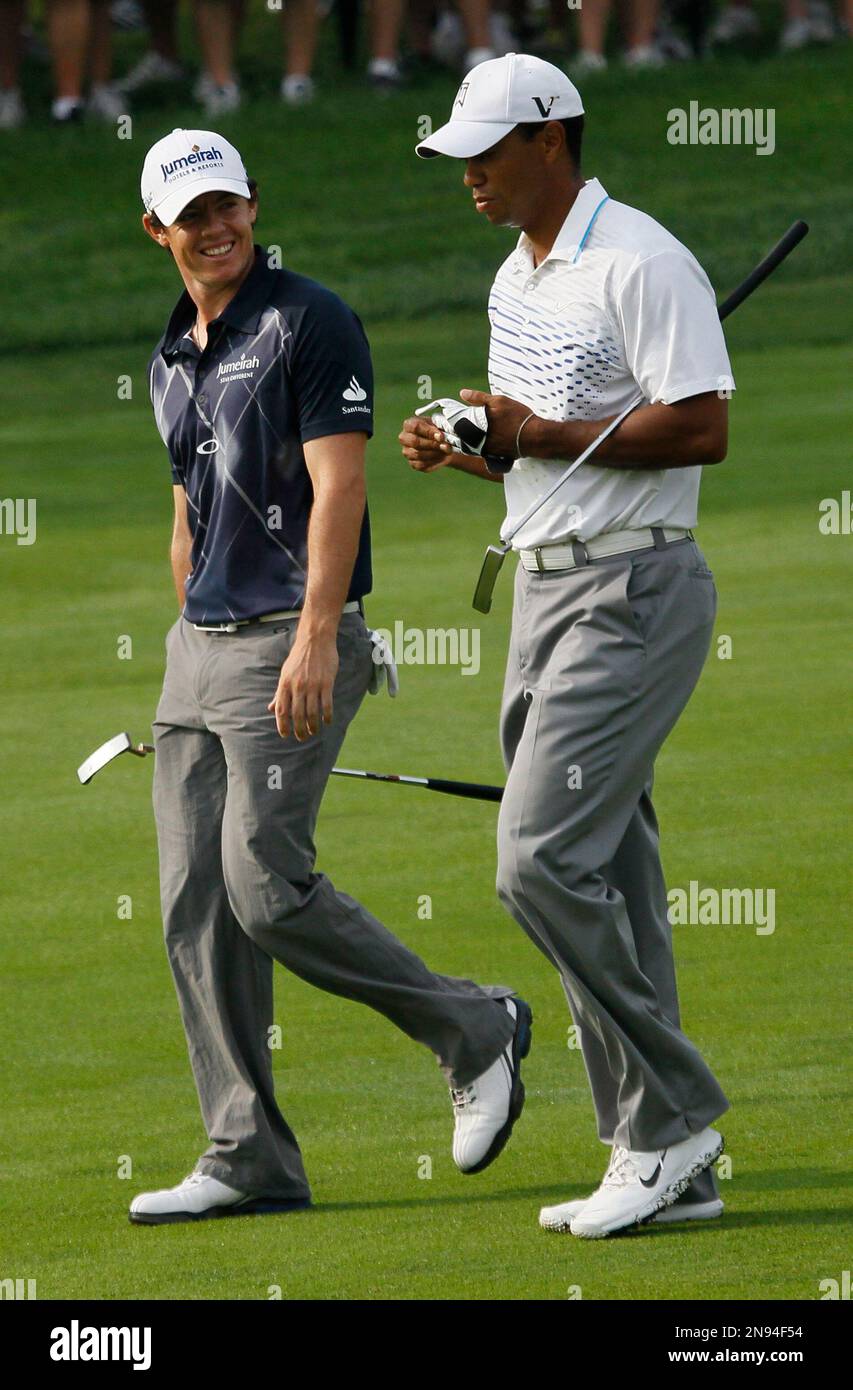 Rory McIlroy of Northern Ireland, left, smiles at Tiger Woods on the