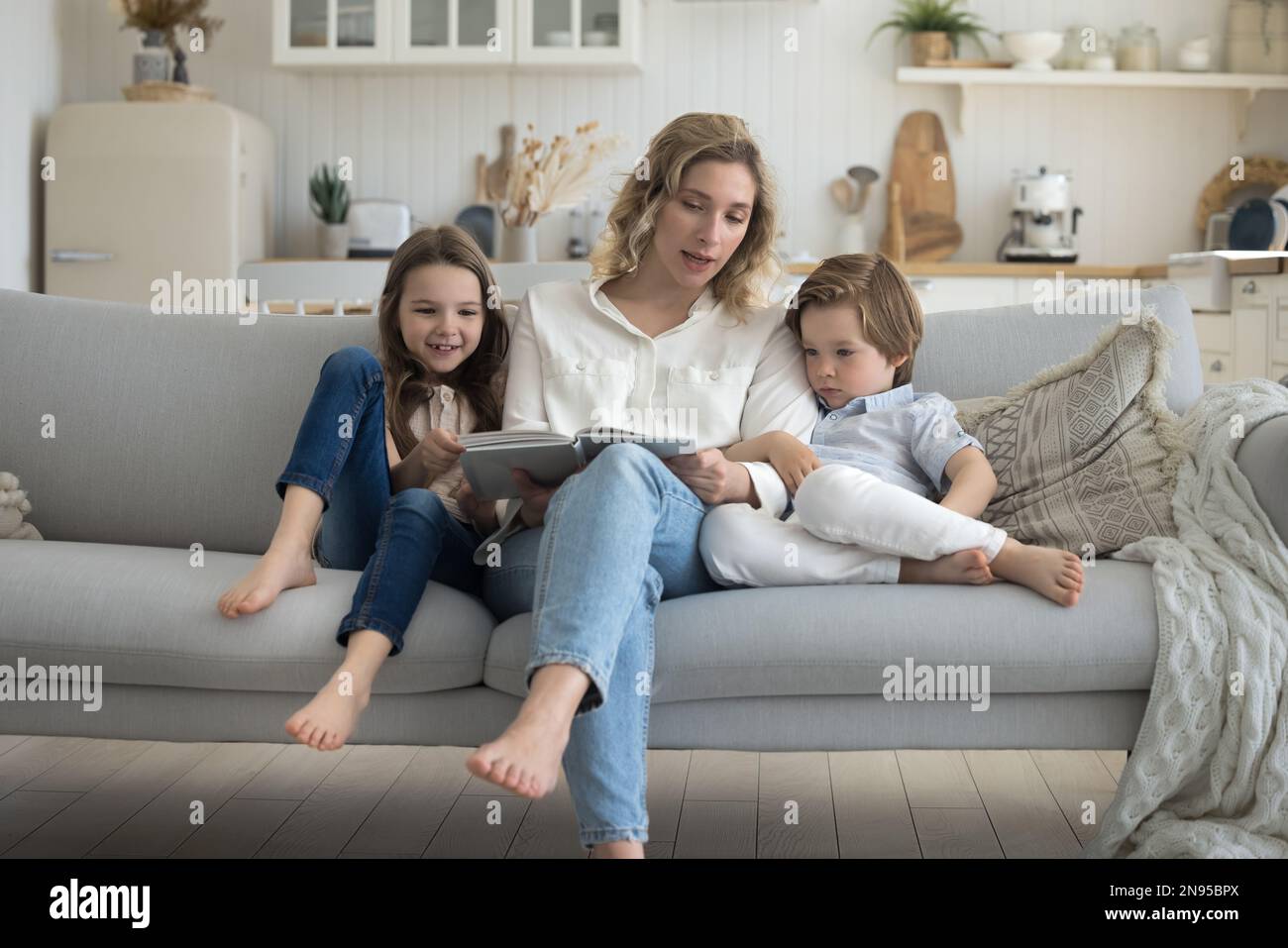 Young daycare teacher woman reading book to kids stock photo alamy