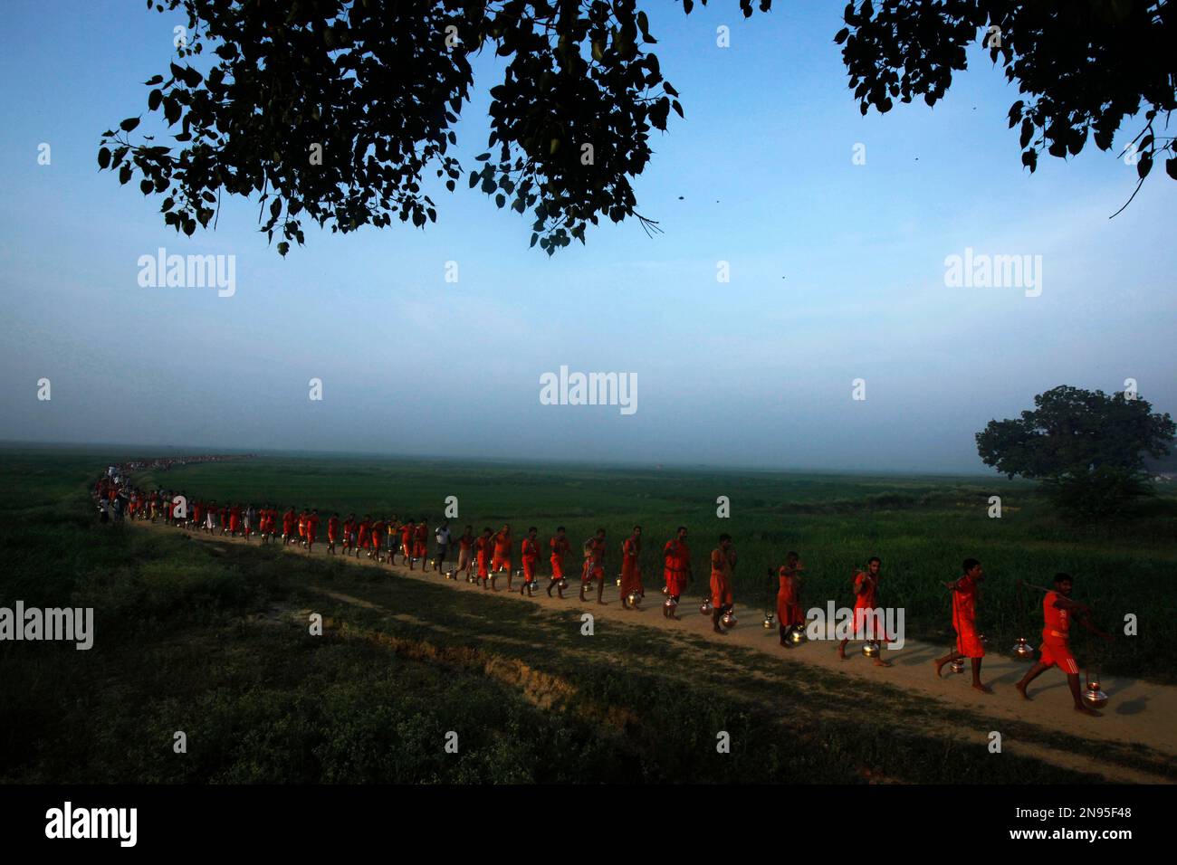 Indian Hindu devotees carrying metal pots filled with water from the