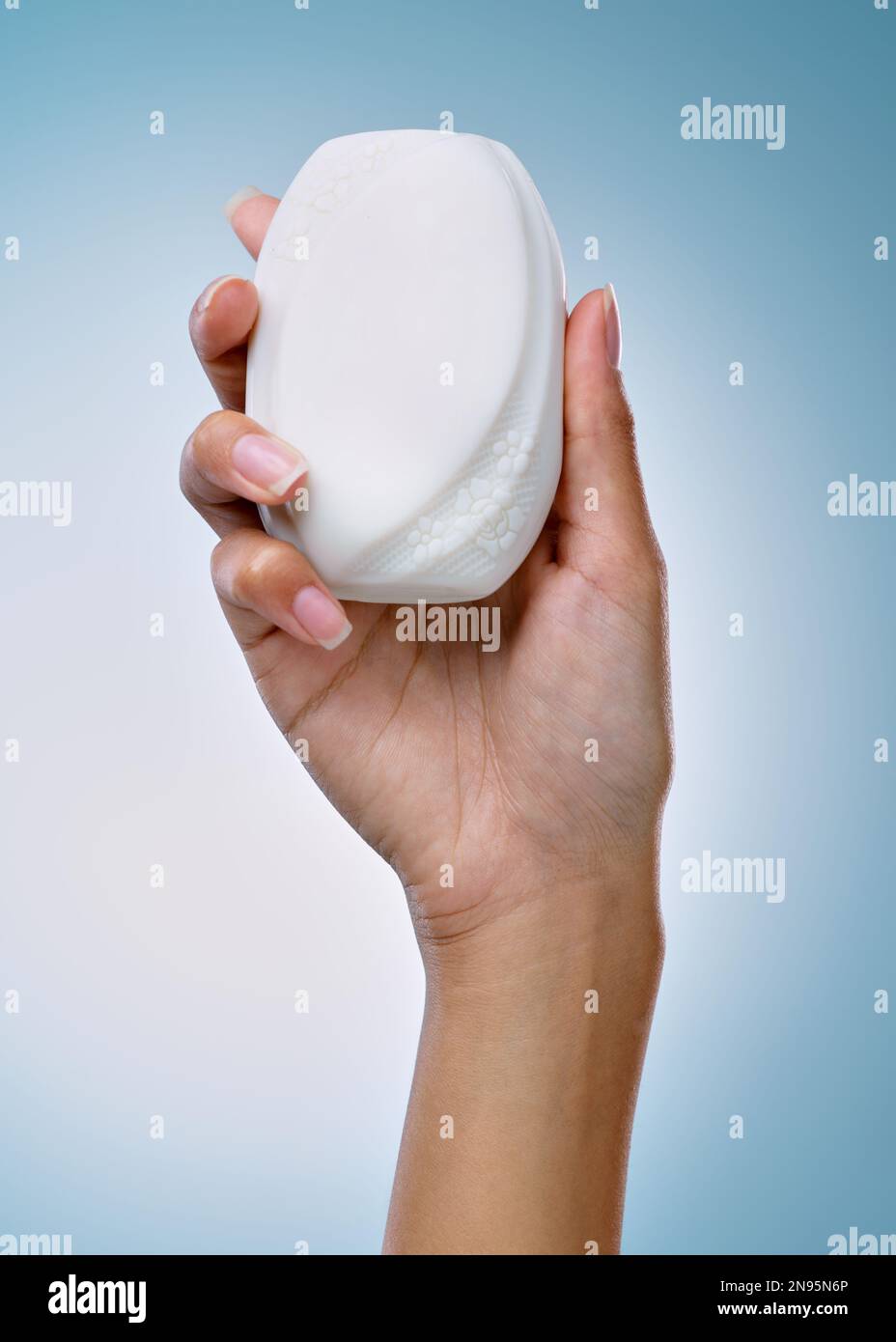 Time to get squeaky clean. an unrecognisable woman holding a bar of