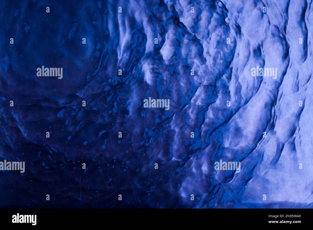 dark blue water surface texture with ripples and splashes. Abstract ...