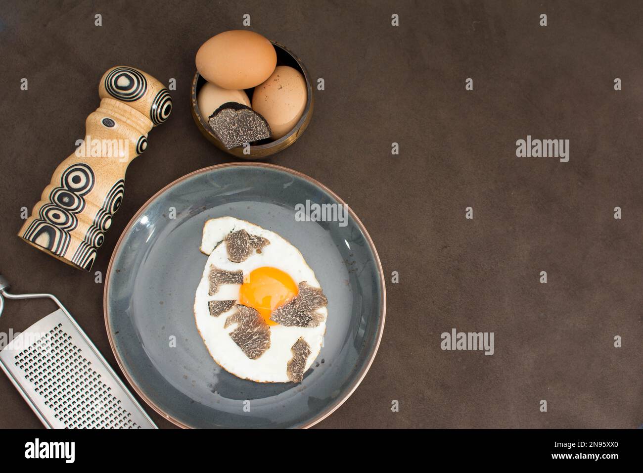 Truffled fried egg with french fries and tuber melanosporum winter