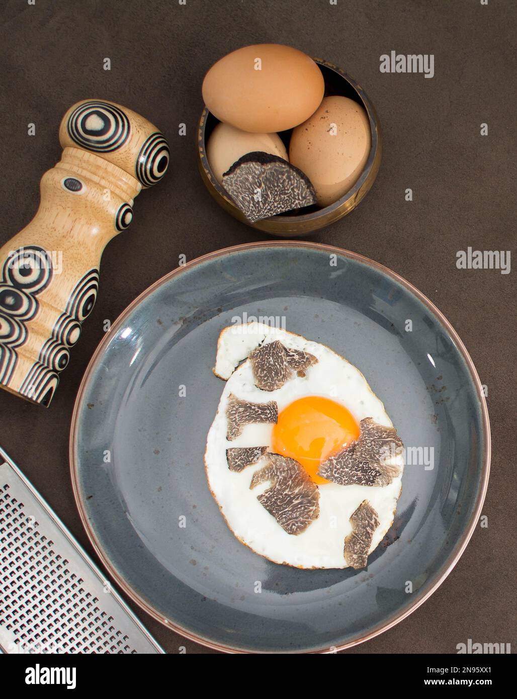 Truffled fried egg with french fries and tuber melanosporum winter