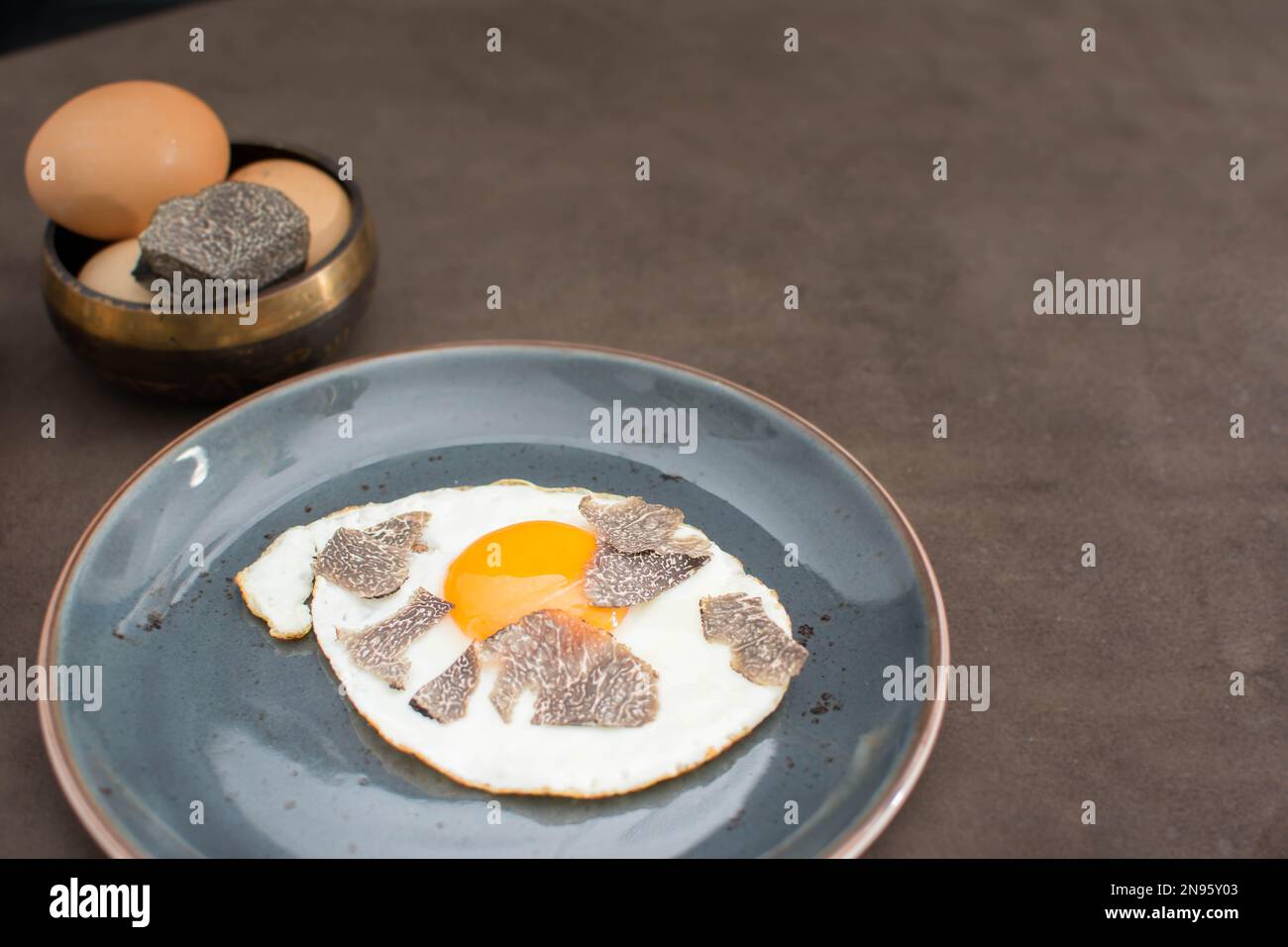 Truffled fried egg with french fries and tuber melanosporum winter