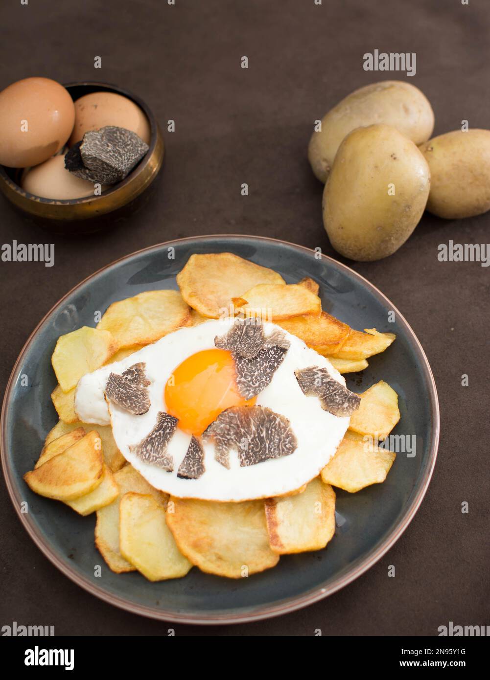 Truffled fried egg with french fries and tuber melanosporum winter