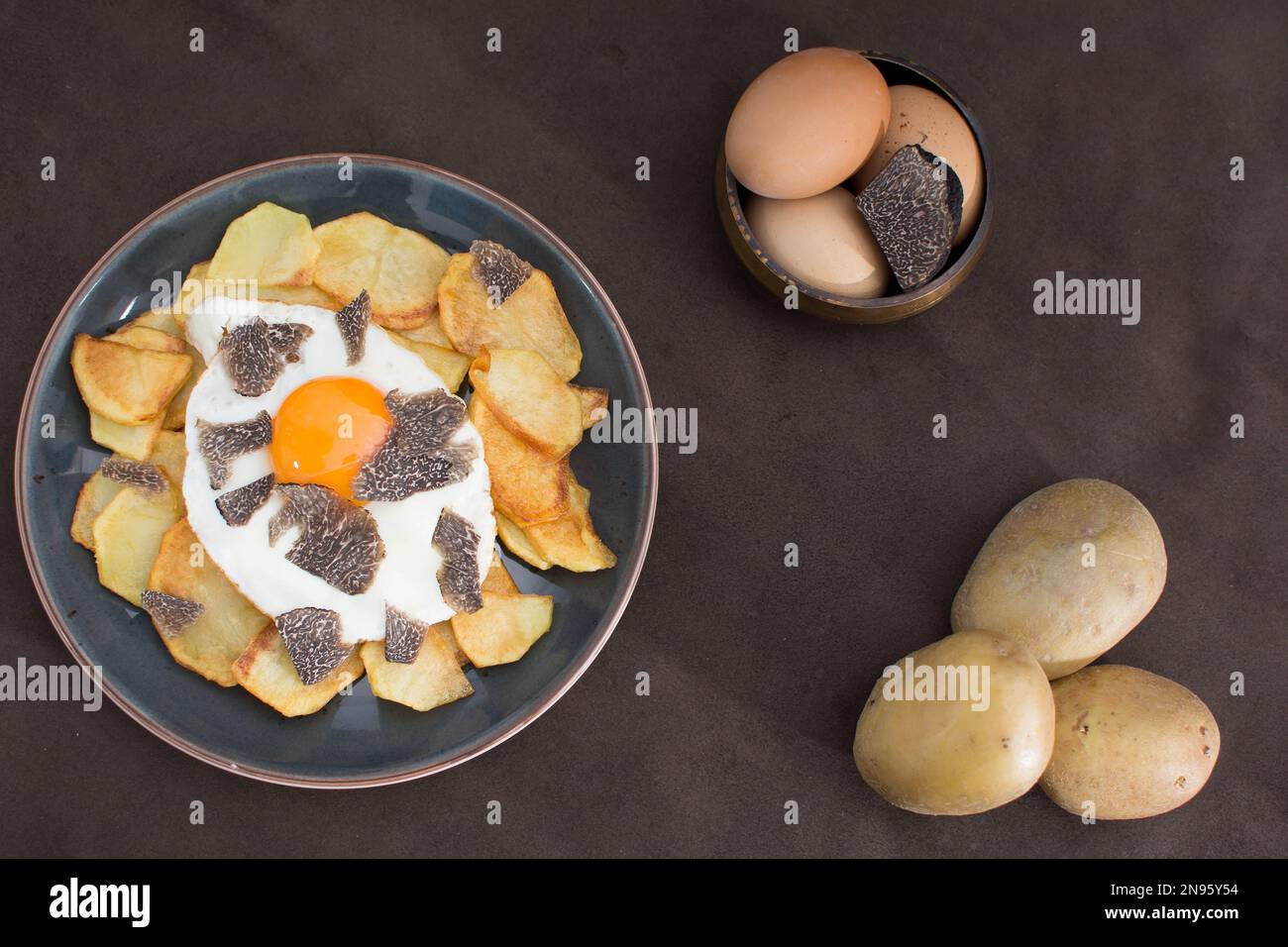 Truffled fried egg with french fries and tuber melanosporum winter