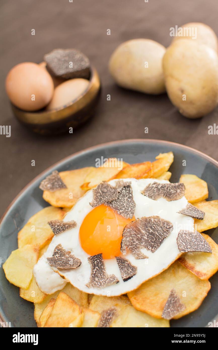 Truffled fried egg with french fries and tuber melanosporum winter