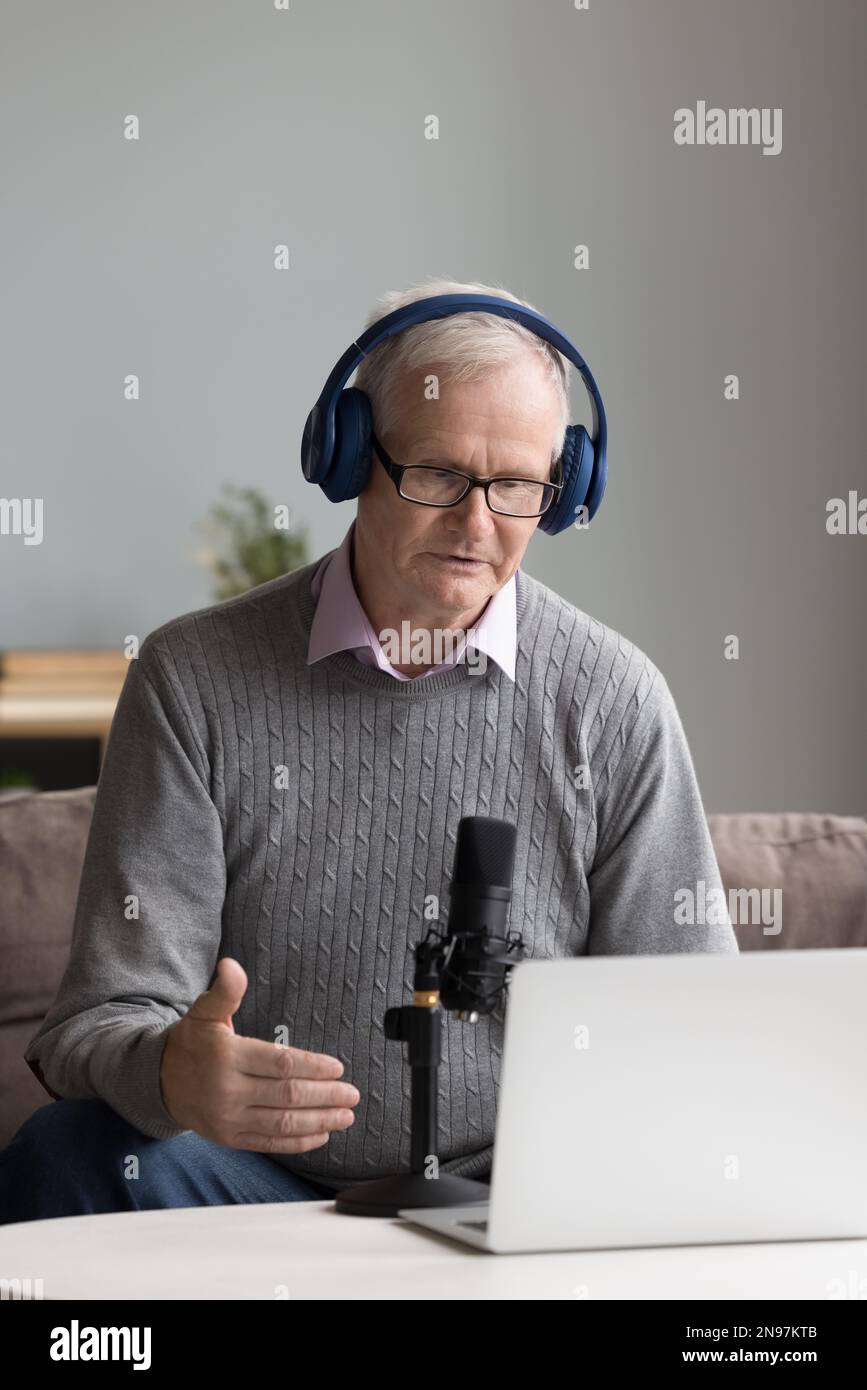 Serious mature influencer recording speech for blog Stock Photo