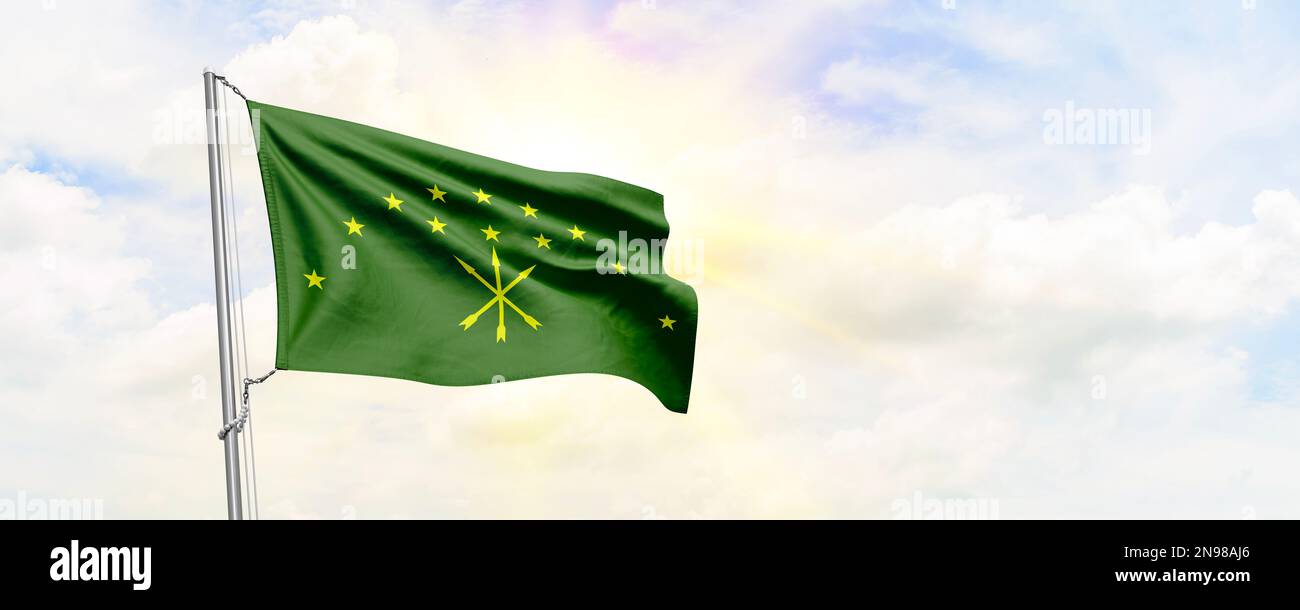 Adygea flag waving on sky background. 3D Rendering Stock Photo