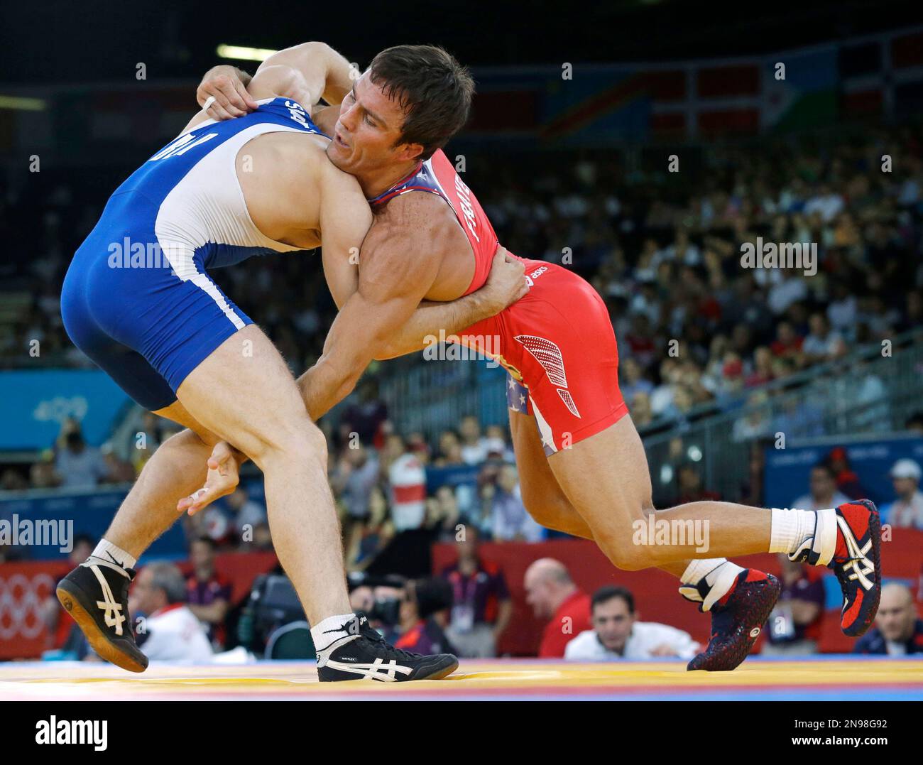 Jared Frayer of the United States, competes with Ali Shabanau of Belarus, (in blue) during their 66-kg freestyle wrestling match at the 2012 Summer Olympics, Sunday, Aug