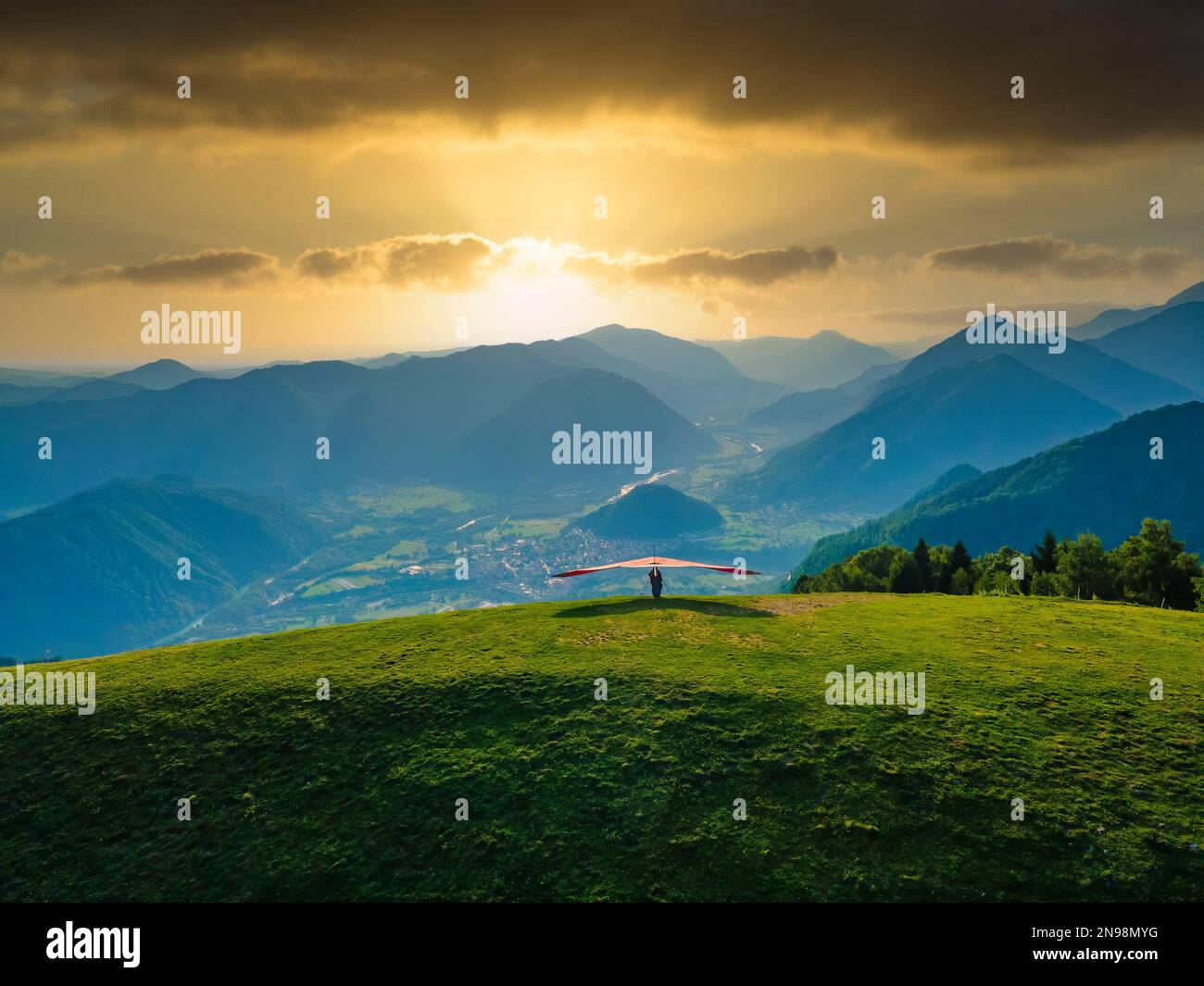Hang glider ready to launch from the green meadow in the mountains. Amazing scene in Soca valley, outdoor sport paradise in Slovenia, Europe Stock Photo