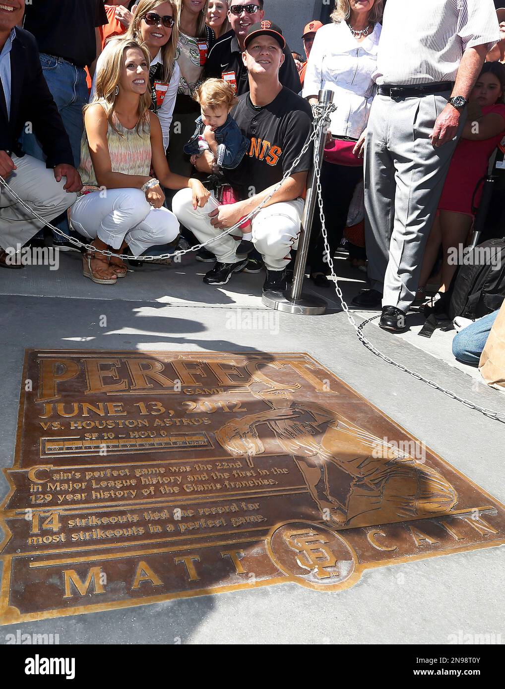 San Francisco Giants pitcher Matt Cain, right, joined by his wife, Chelsea,  and their daughter, Harley Mae, pose for a photo next to a plaque  commemorating his perfect game in June, before