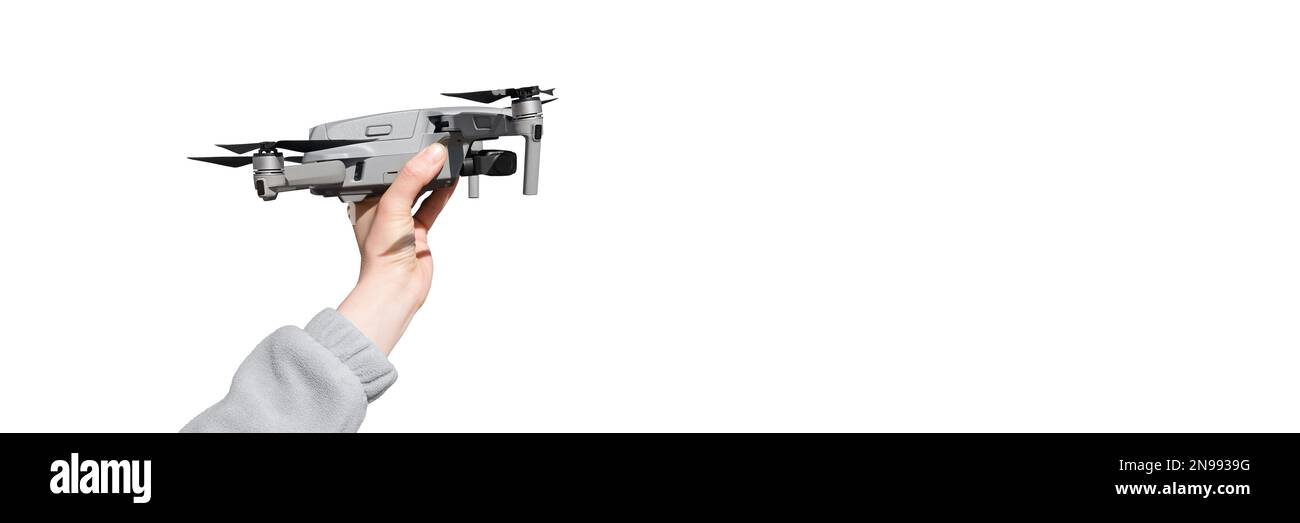 Hand holding drone ready to take off isolated on the whire background