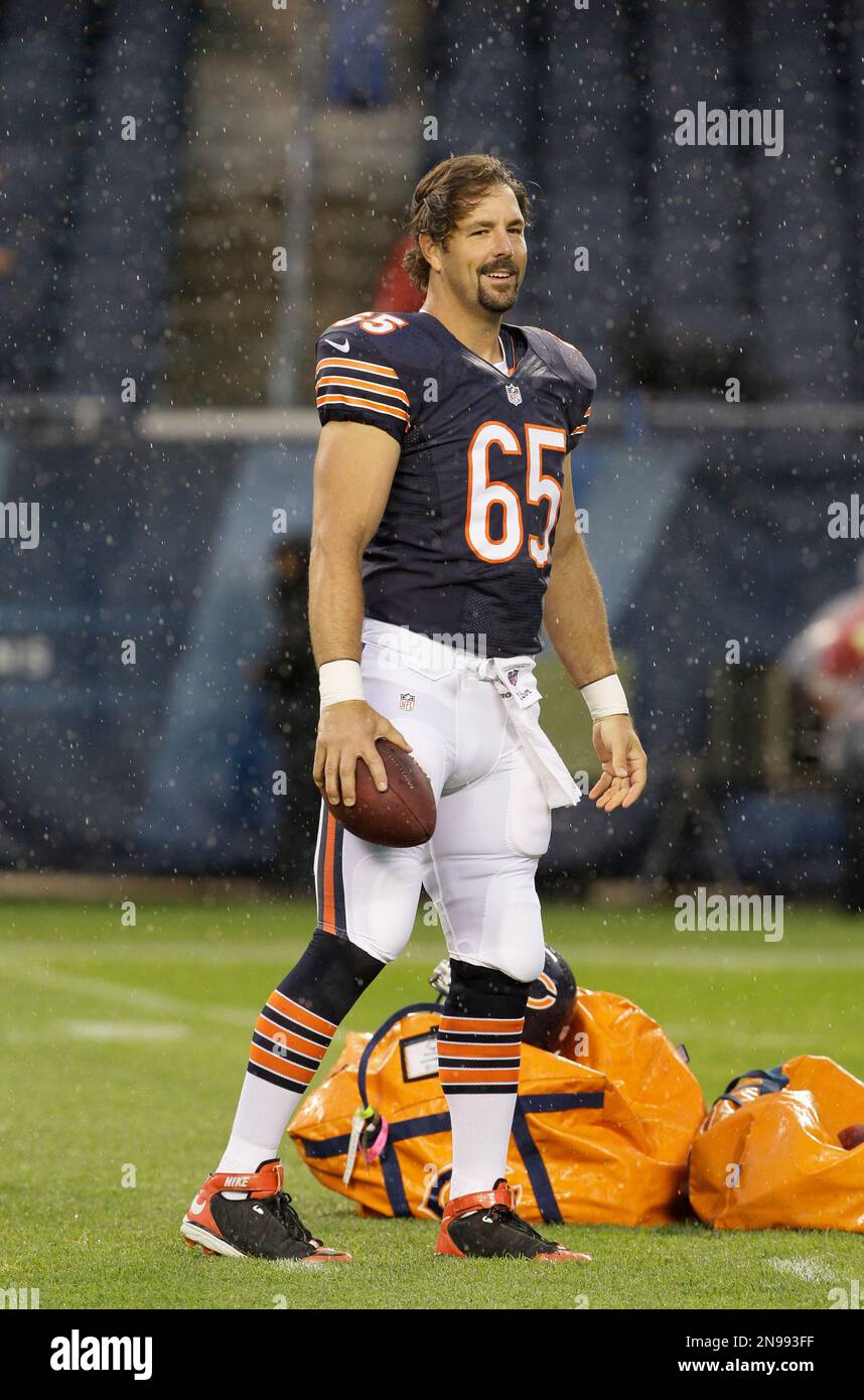 Chicago Bears long snapper Patrick Scales holds his daughter