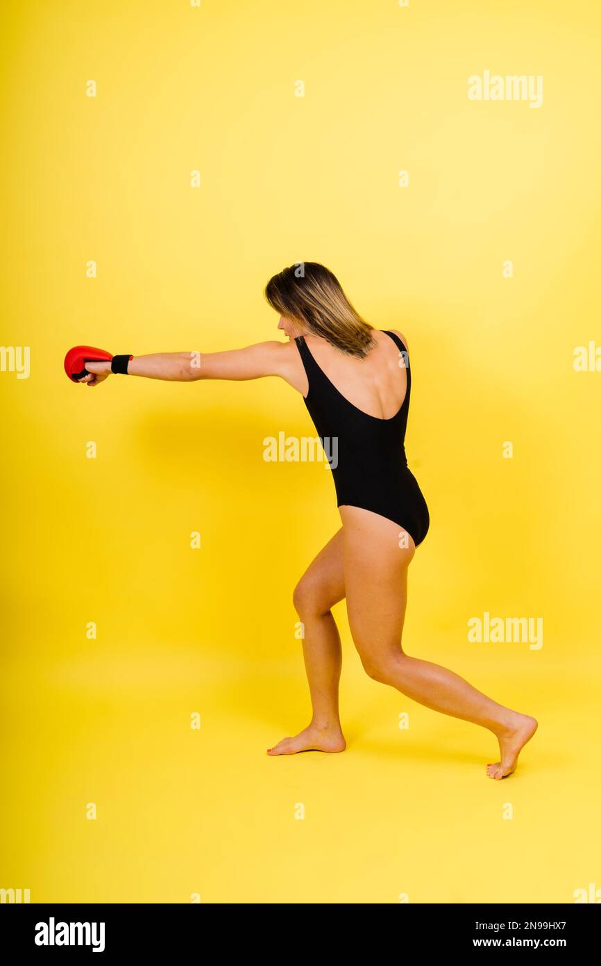 Woman do high kick, taebo. Athletic fit female with perfect body kick air, punching with legs