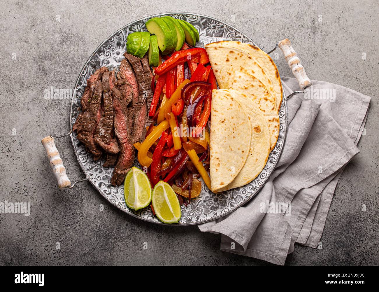 Traditional Mexican dish Beef fajita served with tortillas and ripe