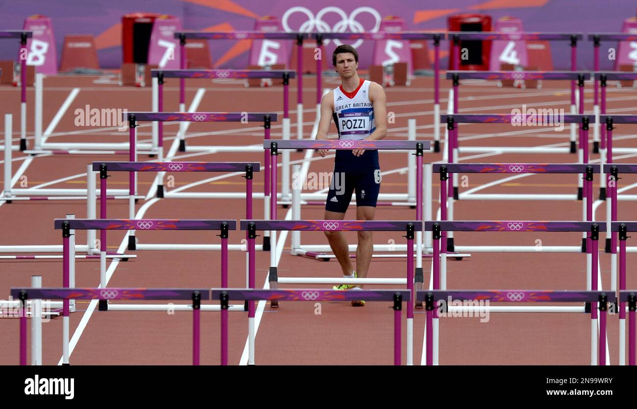 Britain's Andrew Pozzi stops after knocking down a hurdle in a men's