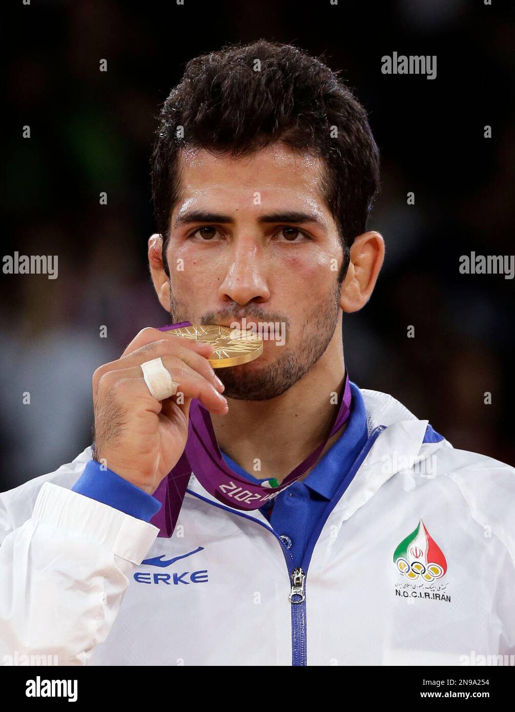 gold-medalist-haji-noroozi-of-iran-shows-his-medal-after-the-victory